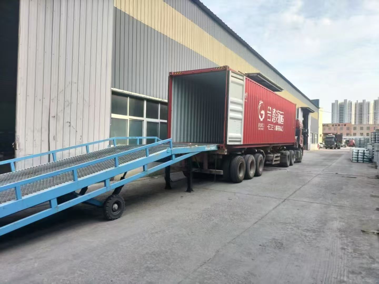 Shipping container backed up to the factory loading ramp