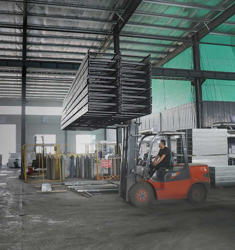 Forklift moving bundled cable ladders inside the Hongfeng workshop